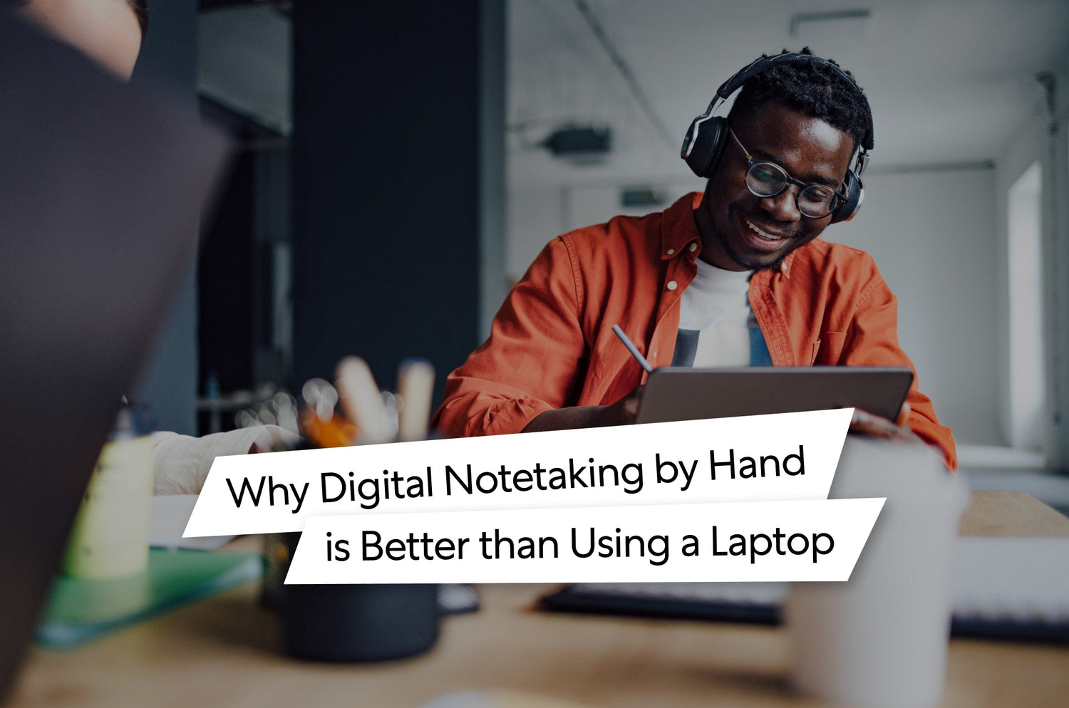 Why Digital Notetaking by Hand is Better than Using a Laptop. Someone writing on an iPad at an office table.