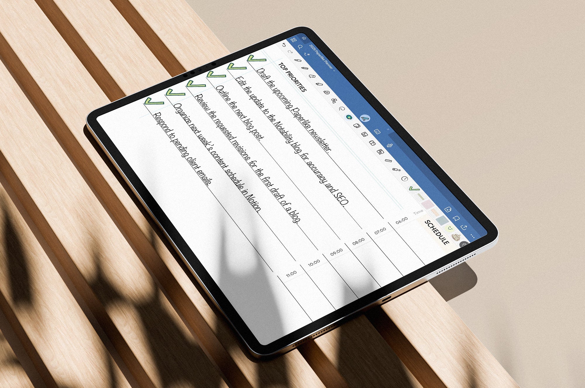 An iPad with a task list on the screen, lying on a slatted, wood bench.