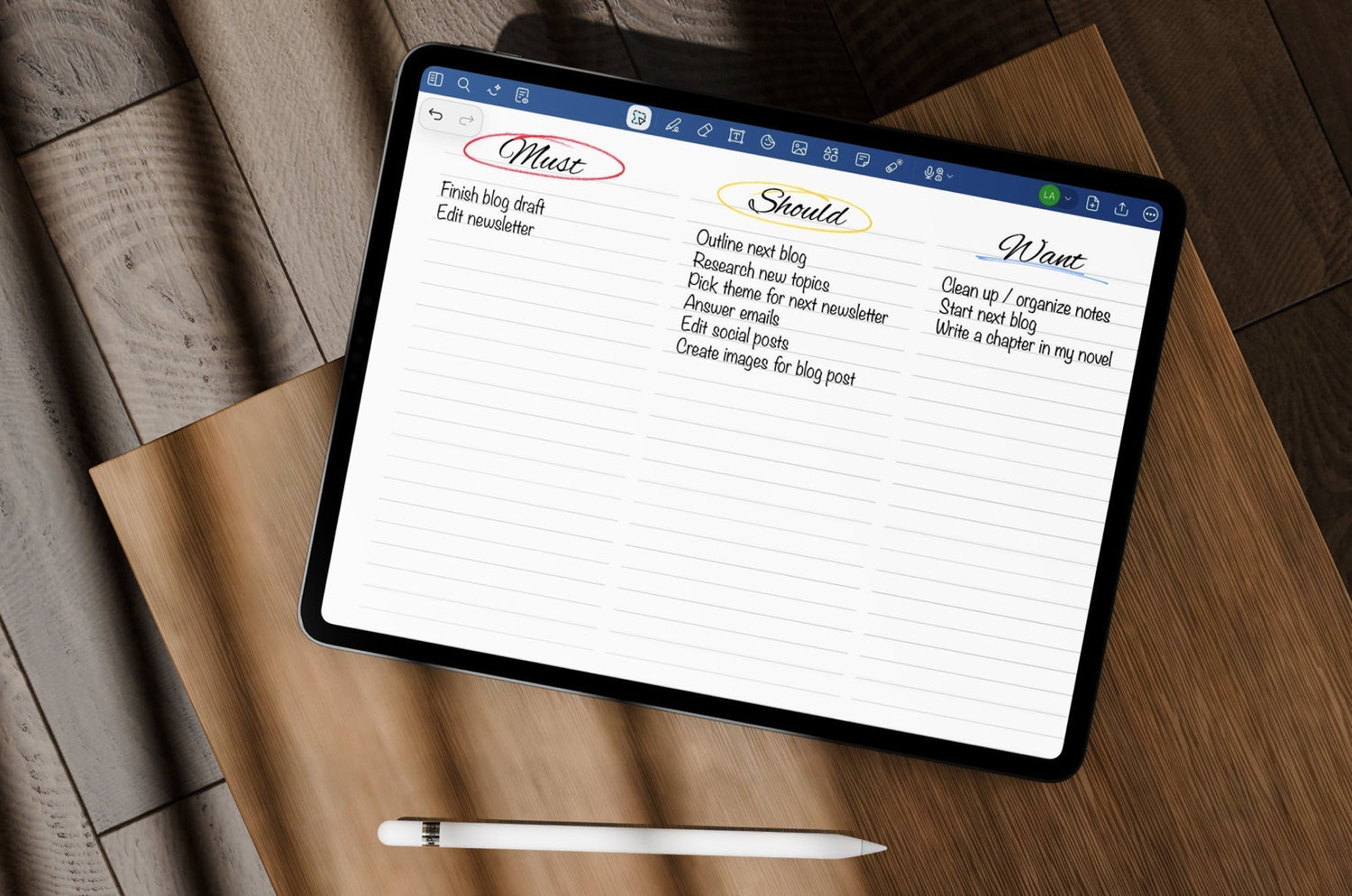 An iPad sitting on a desk with an Apple Pencil underneath it and a Must, Should, Want task list open on the screen.