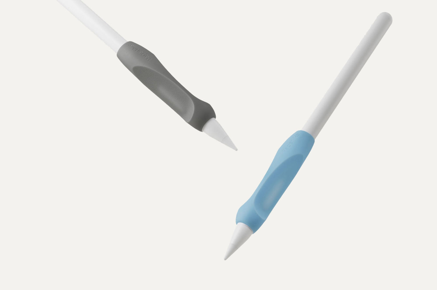 Two Apple Pencils with Paperlike™ Pencil Grips, one in gray and one in blue, shown against a white background.