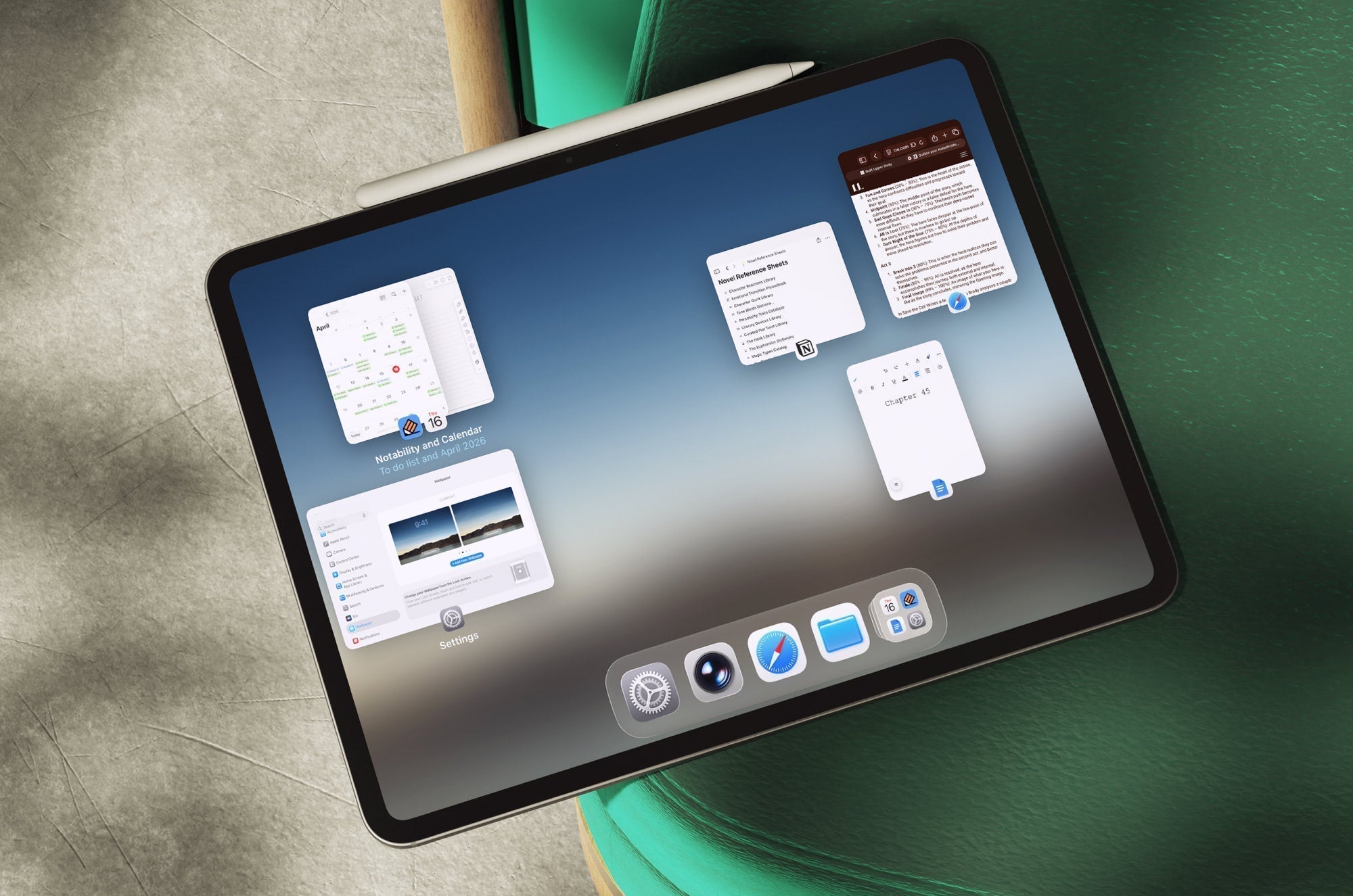 An iPad laying on a green chair, showing how Stage Manager groups windows.