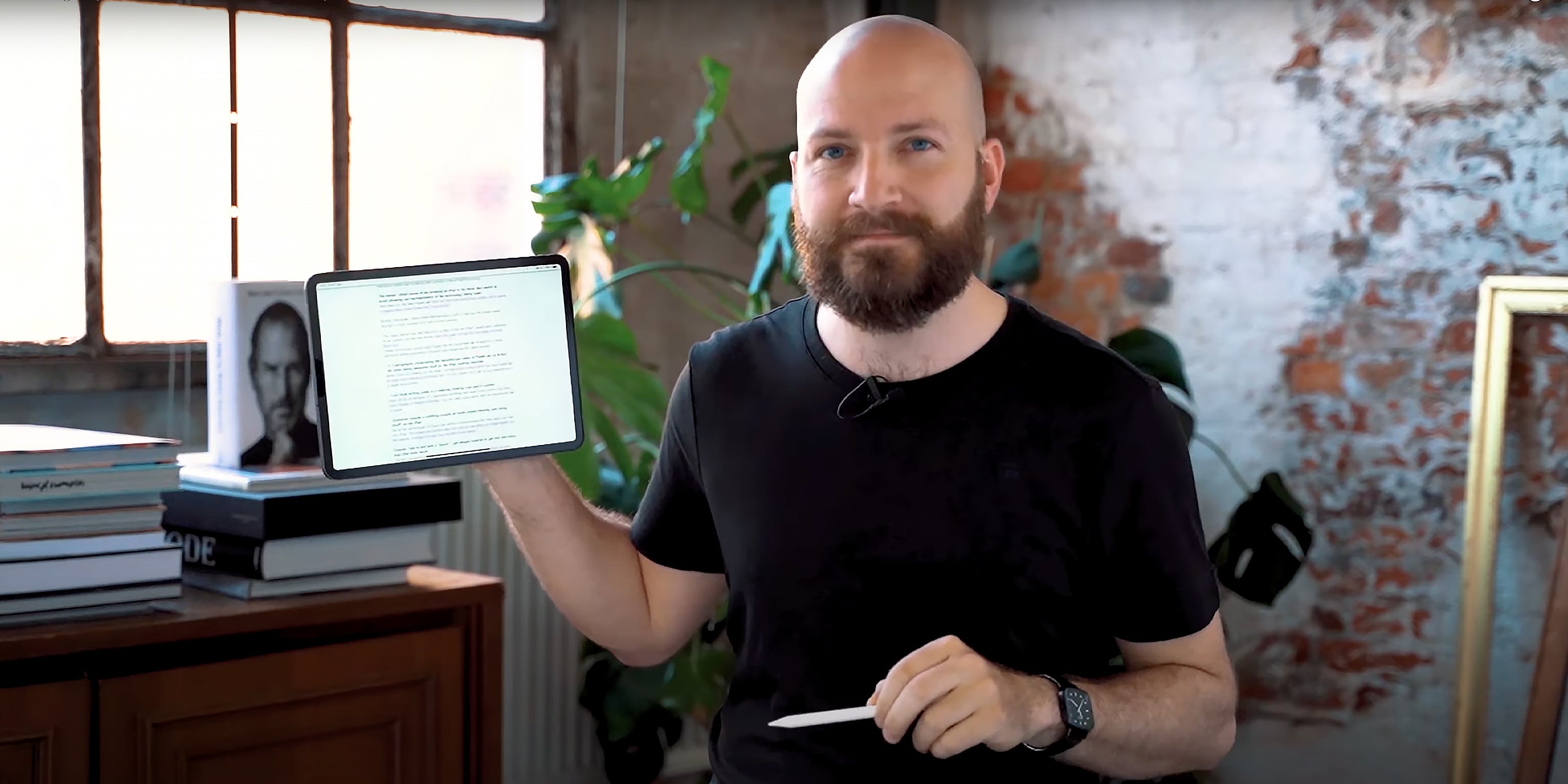 Paperlike’s founder and CEO, Jan Sapper, holds up an iPad in one hand and an Apple Pencil in the other.
