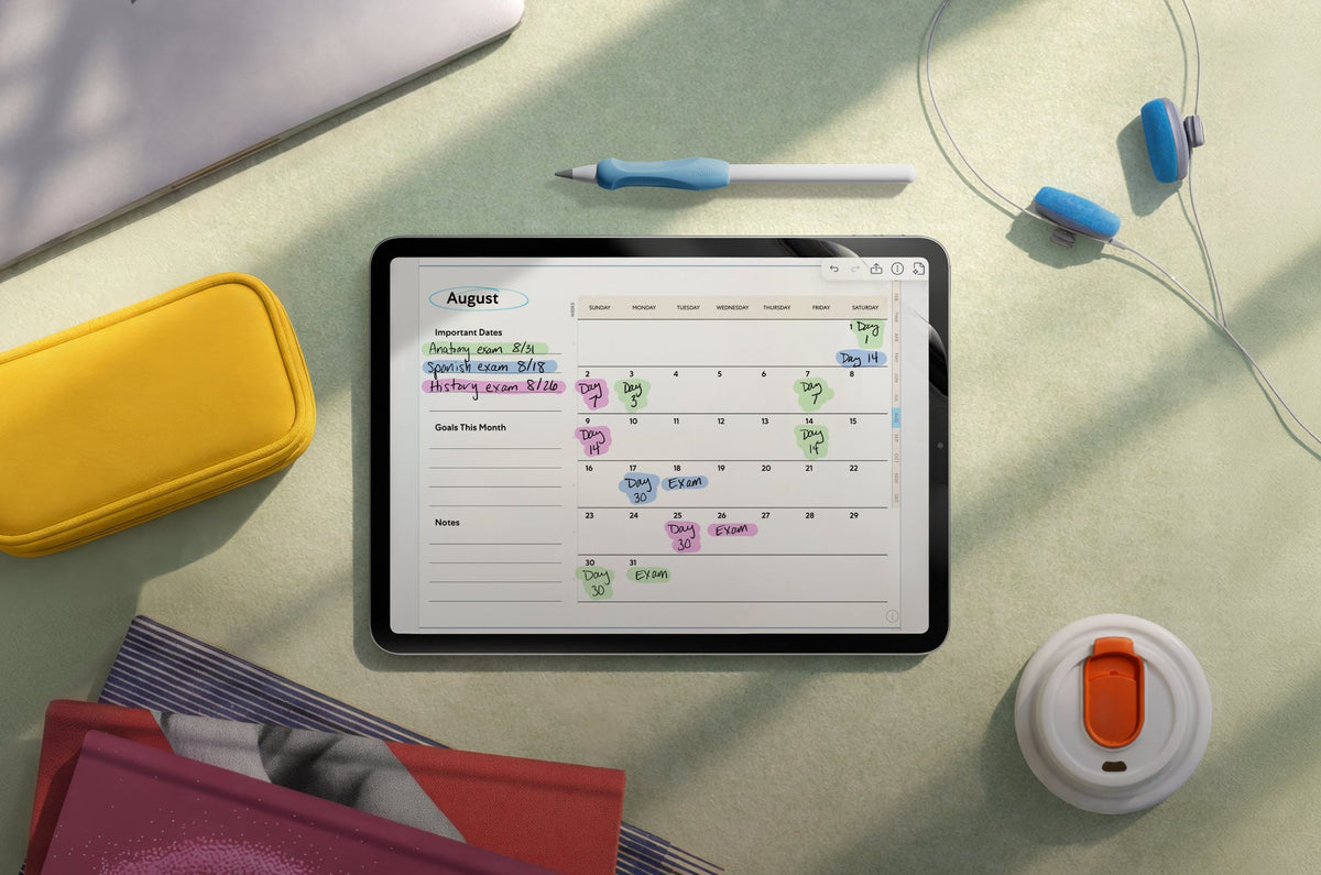 An iPad with a digital planner on the screen, surrounded by other accessories.