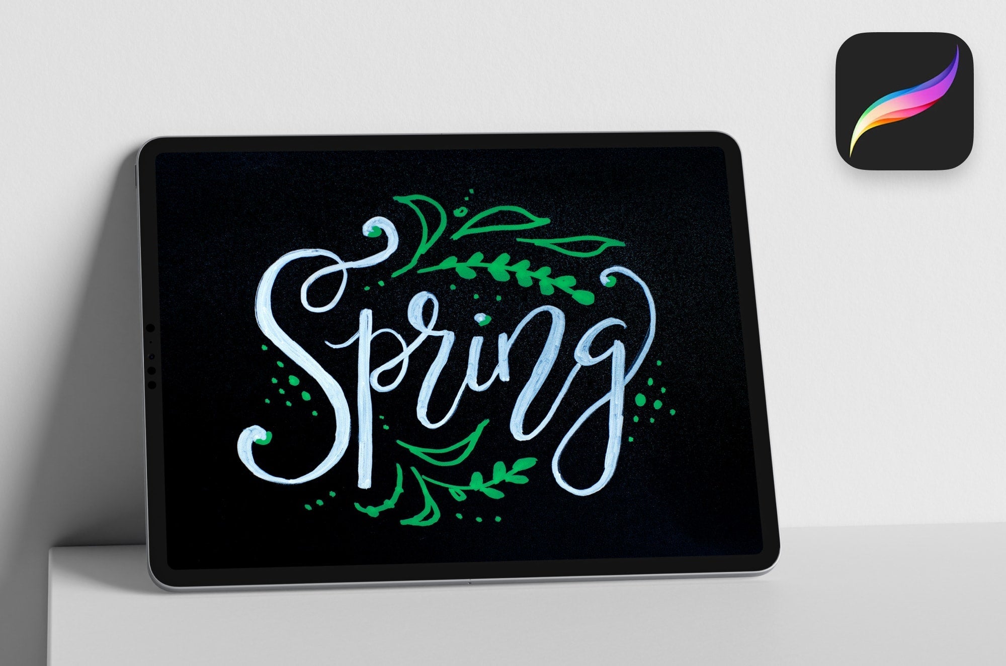 An iPad with the hand-lettered word "Spring" on it in Procreate.